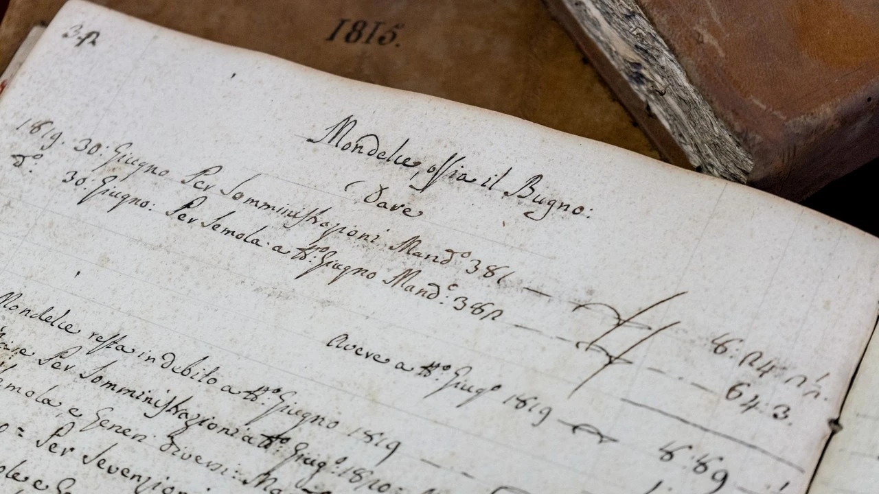 A handwritten nineteenth-century ledger page with amounts in the margin, beside an old account book